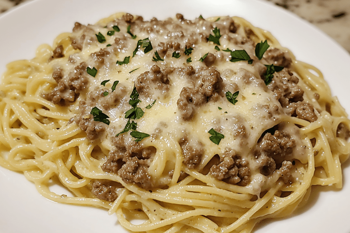 Savory garlic Parmesan beef mixed with spaghetti pasta, topped with melted cheese for a comforting and flavorful dish.