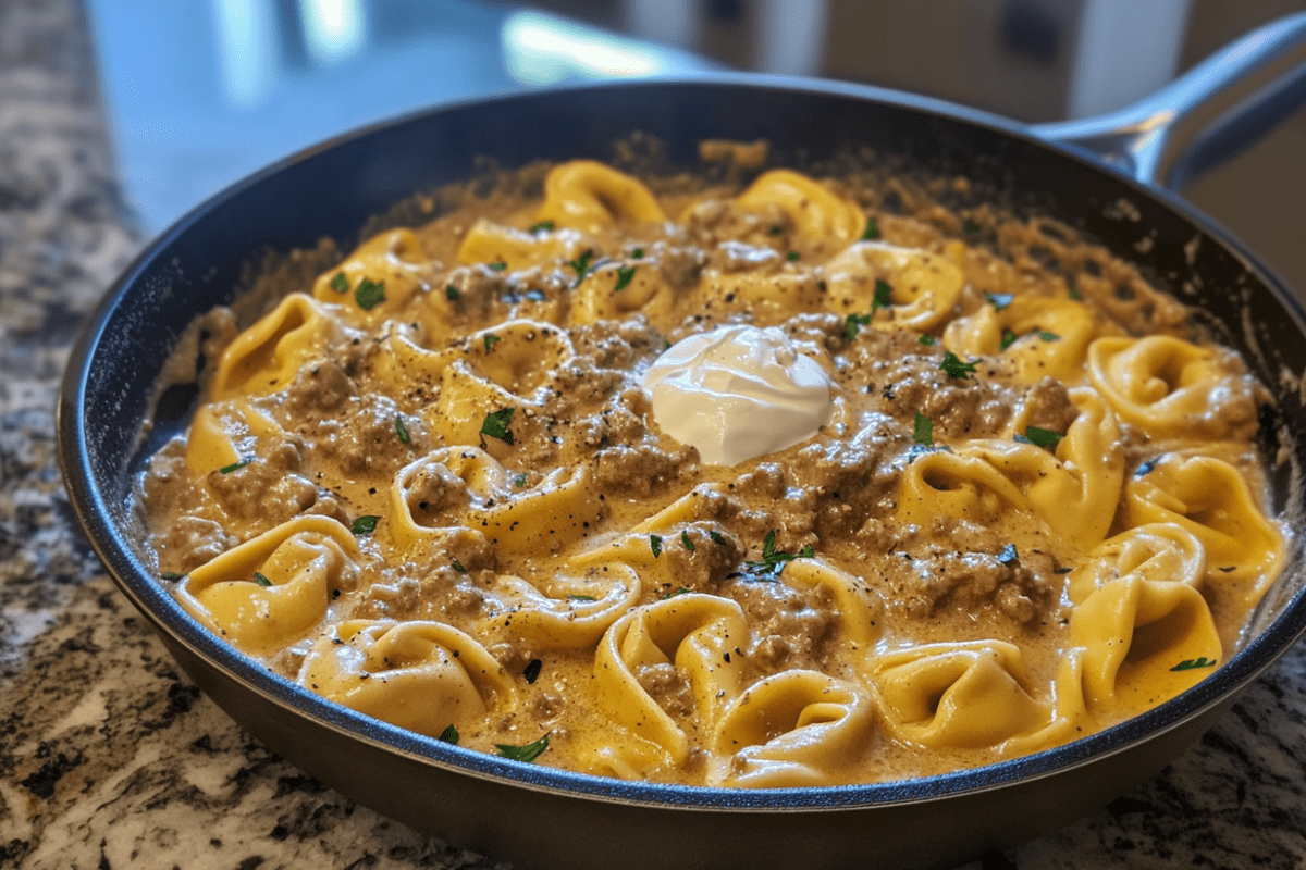 A skillet filled with creamy Beef Stroganoff Tortellini, featuring tender beef, mushrooms, and a rich sauce.