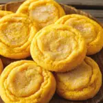 Soft batch pumpkin sugar cookies dusted with cinnamon sugar, served on a plate as a cozy fall dessert.